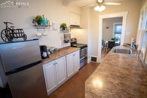 a kitchen with sink refrigerator and stove