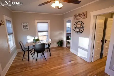 a view of a dining room with furniture window and wooden floor
