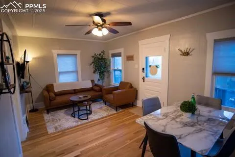 a living room with furniture or chandelier and a wooden floor