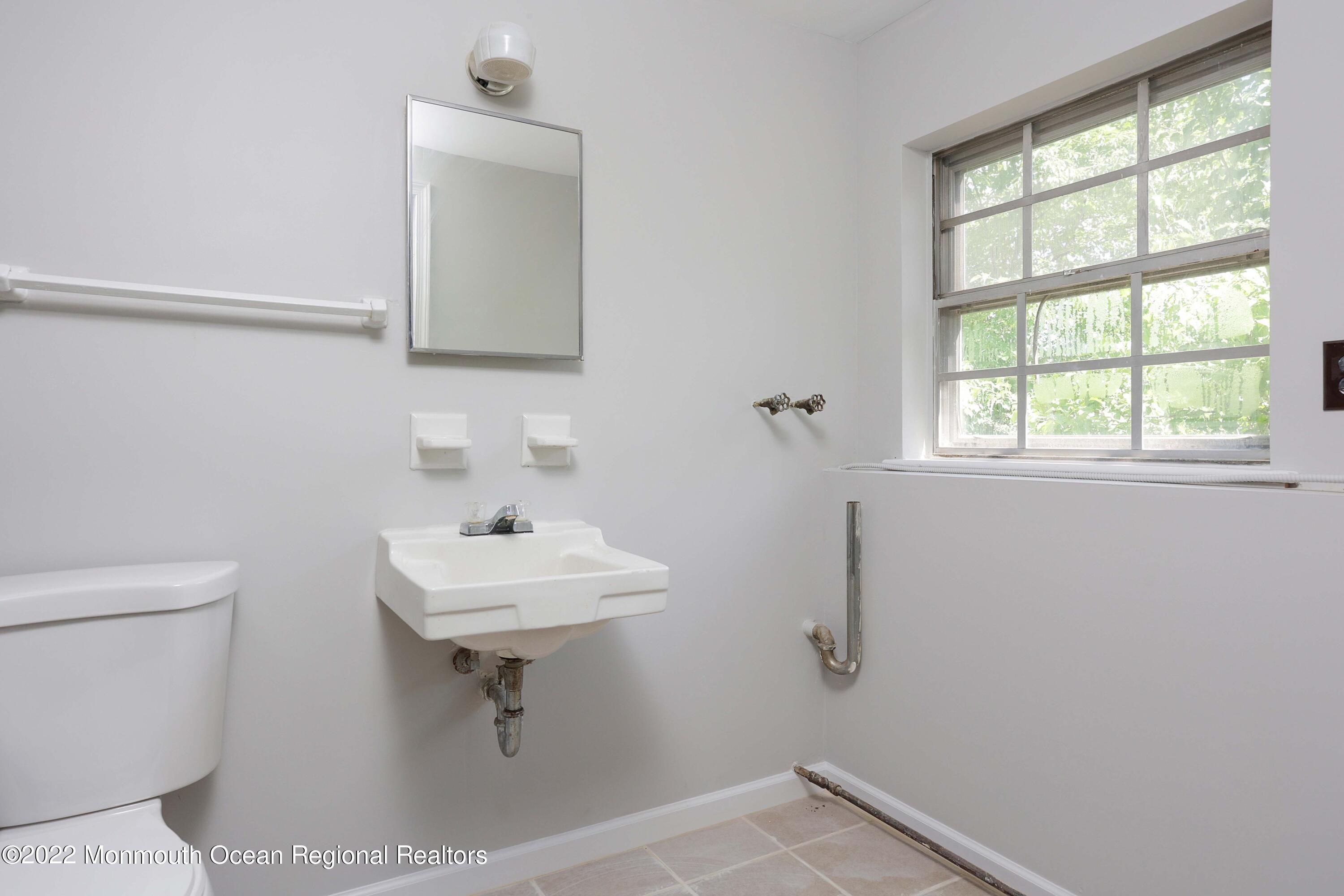 53 Valley Road Jackson, NJ 08527 - Photo 11 of 11 a bathroom with a sink a mirror and a toilet