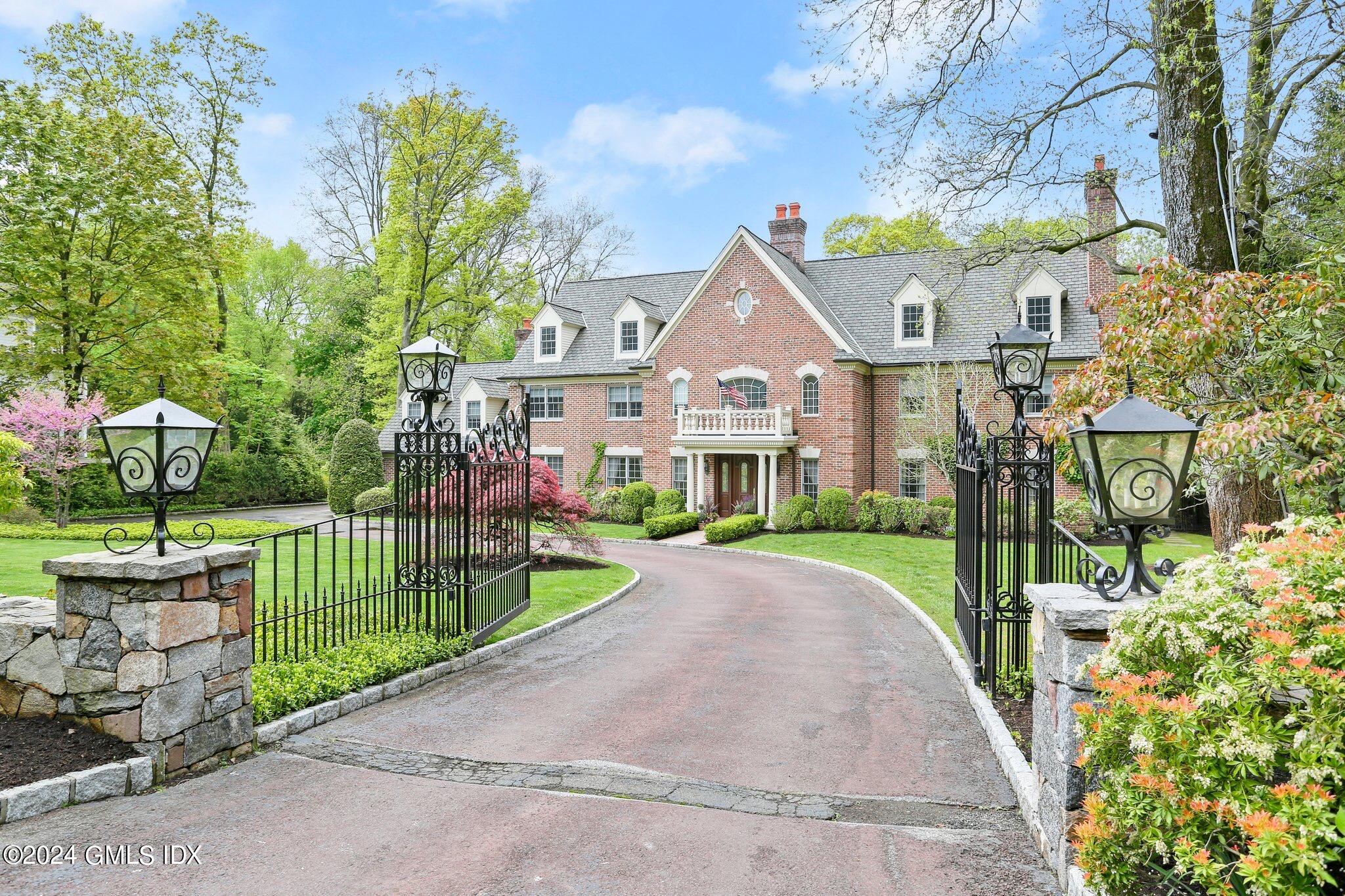 376 Westover Road Stamford, CT 06902 - Photo 1 of 37 a view of a brick house with a big yard plants and large trees