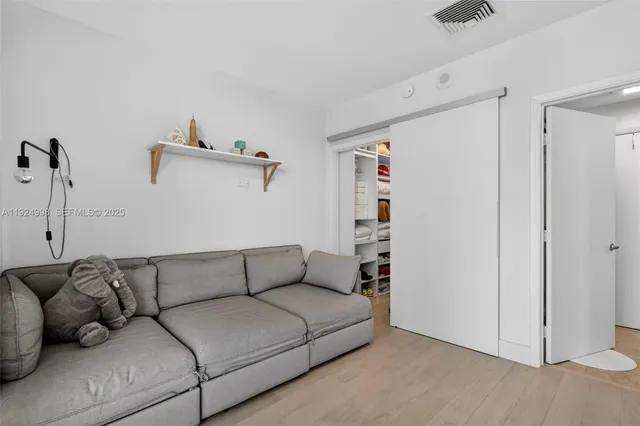 a living room with furniture and a walk in closet