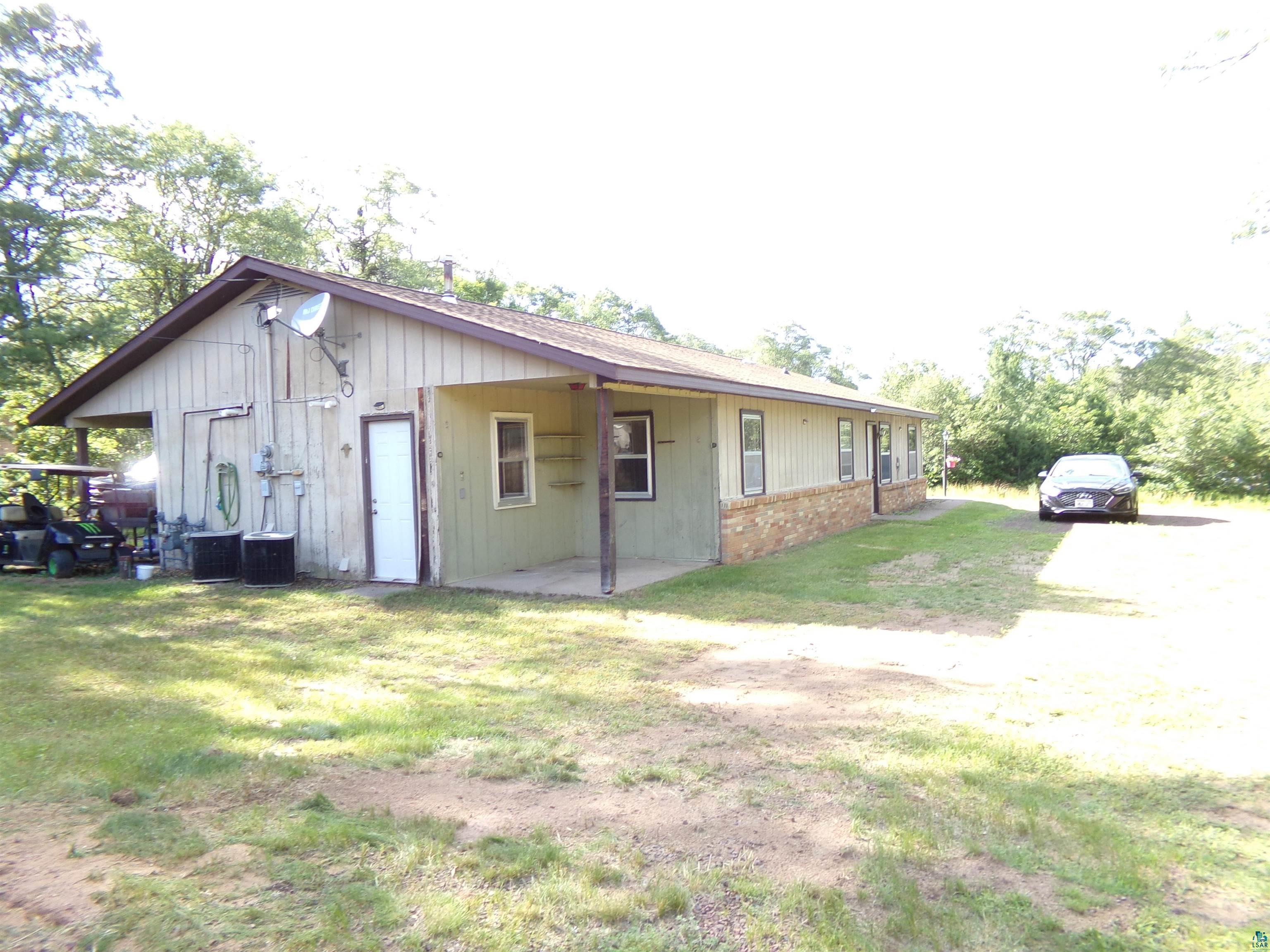 9039 Biller Loop Solon Springs, WI 54873 - Photo 15 of 17 Rear view of property with a yard and central air condition unit