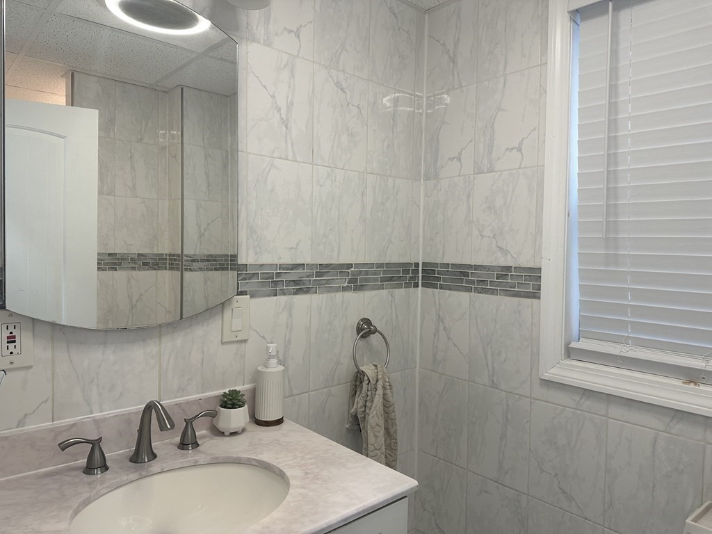 113 Boston Street Methuen, MA 01844 - Photo 11 of 19 a bathroom with a sink and a mirror