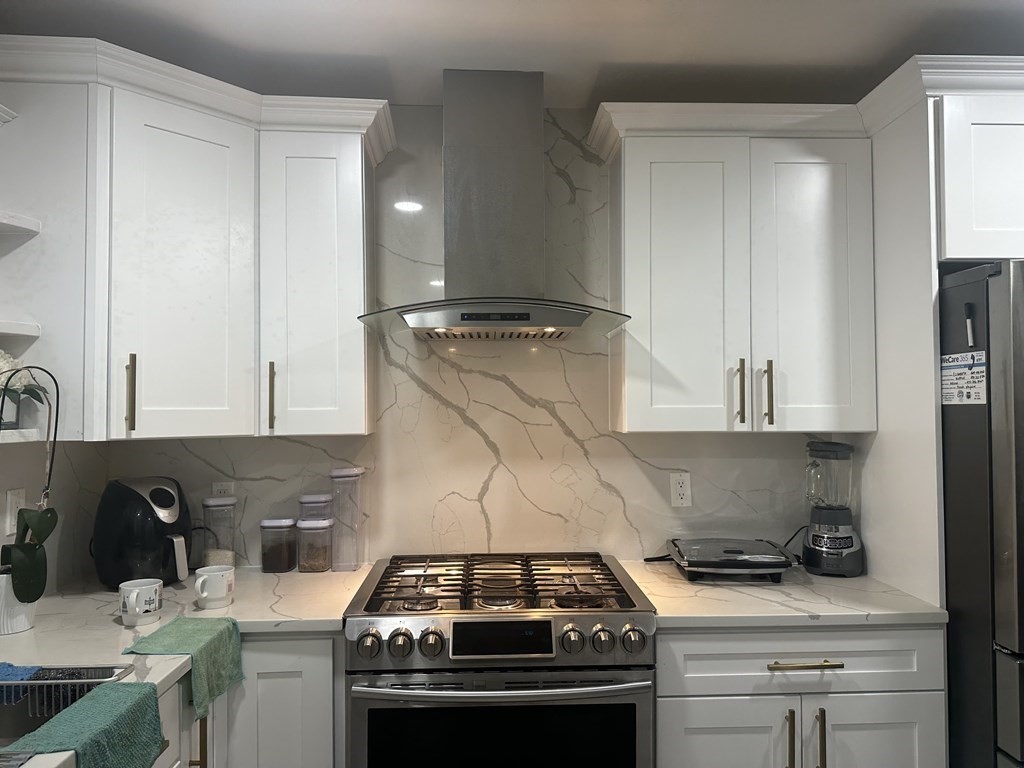 113 Boston Street Methuen, MA 01844 - Photo 6 of 19 a kitchen with a stove and a sink