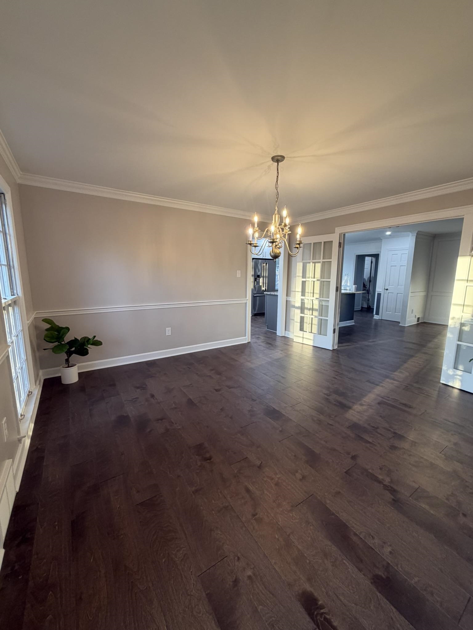 2960 South Germantown Road Germantown, TN 38138 - Photo 14 of 36 an empty room with wooden floor and chandelier