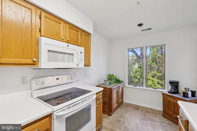 a kitchen with a stove a sink and a microwave