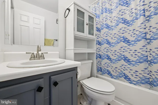 a bathroom with a sink toilet and mirror