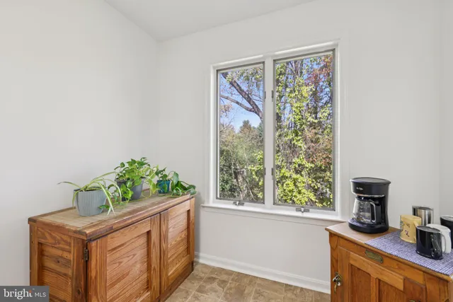 a view of bathroom with a large window and tub