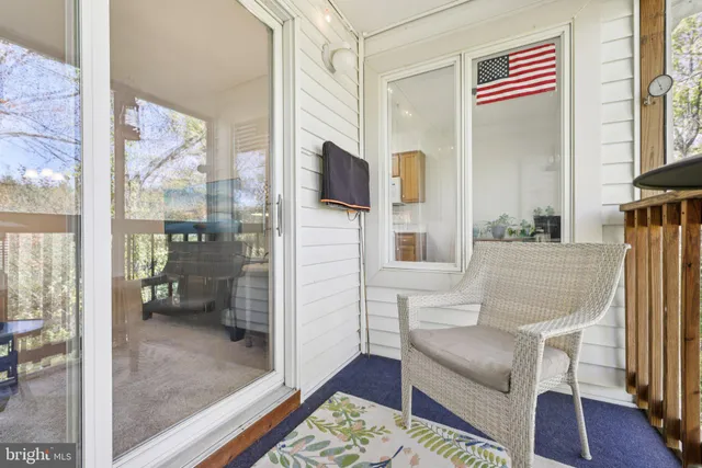 a view of a porch with chairs and backyard