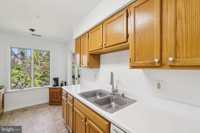 a kitchen with granite countertop a sink and a window