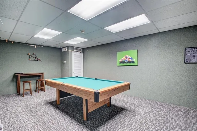 a kitchen with granite countertop a sink a stove and cabinets