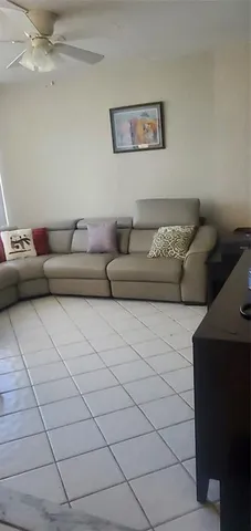 a bedroom with a bed and ceiling fan