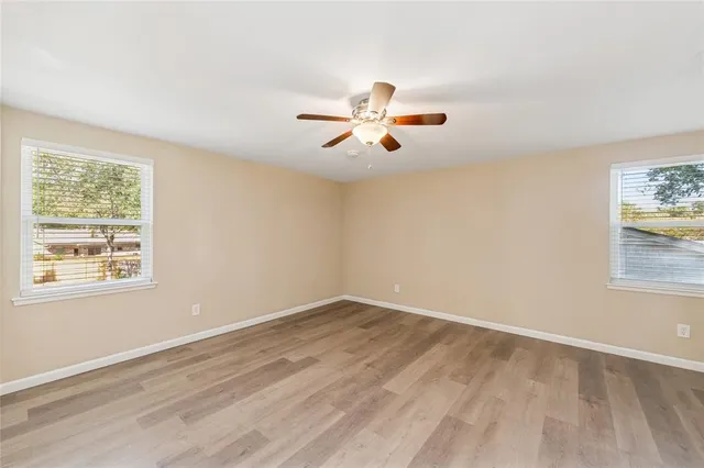 wooden floor in an empty room with a window