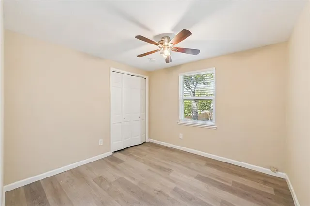 a view of a livingroom with a ceiling fan and window