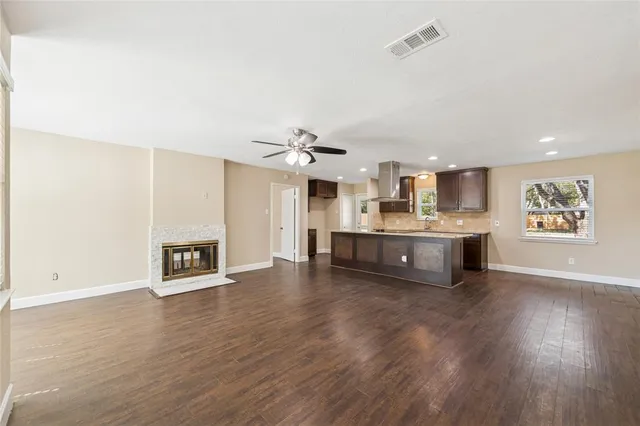 a large white kitchen with a stove top oven