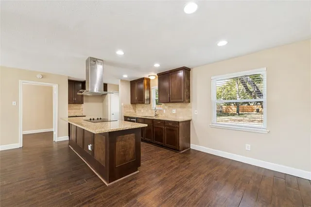 a kitchen with a stove a sink and a microwave