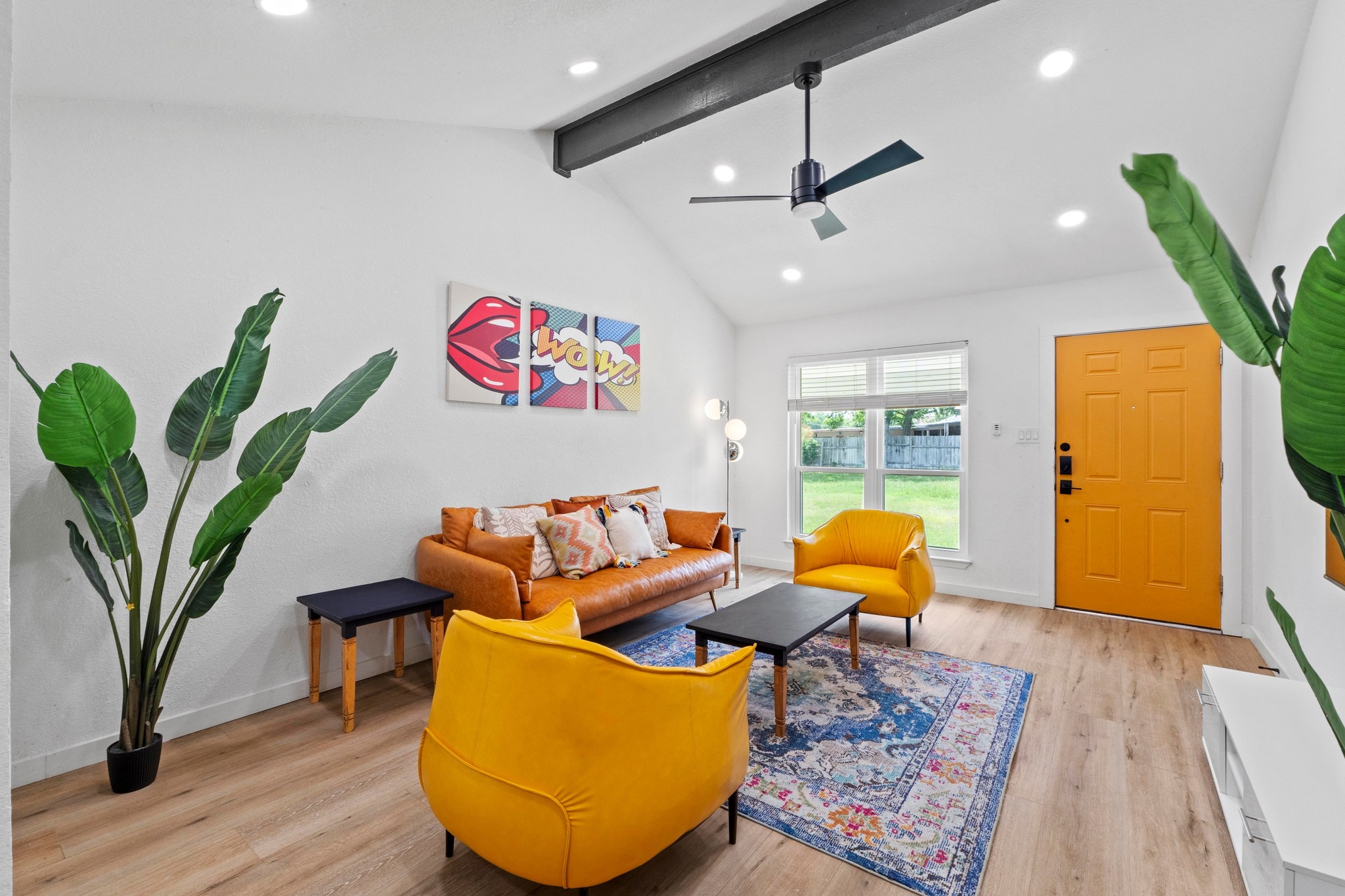 10601 Macmora Road, Unit B Austin, TX 78758 - Photo 1 of 22 A well-lit living area showcases a high vaulted ceiling and contemporary flooring.