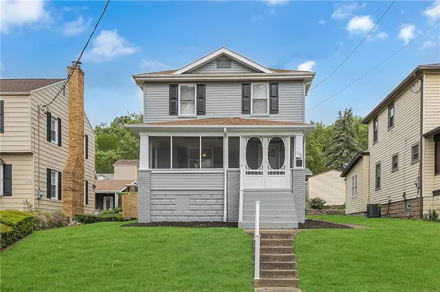 a front view of a house with a yard