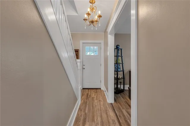 a view of a hallway with wooden floor and entryway