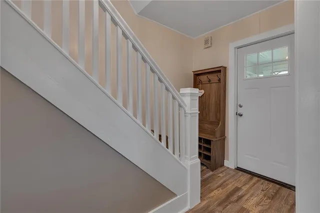 a view of staircase with railing and white walls
