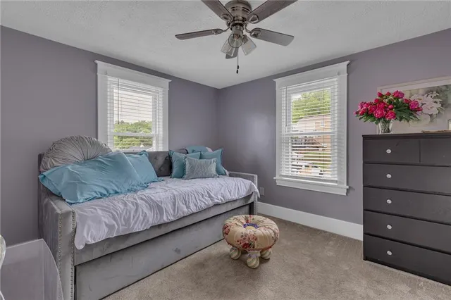 a bathroom with a granite countertop sink toilet and mirror