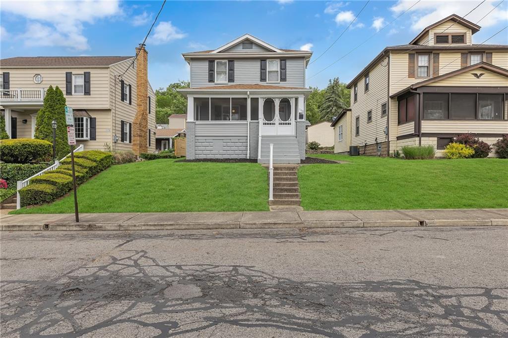 1160 6th Street Beaver, PA 15009 - Photo 2 of 31 a view of a brick house next to a yard with big trees