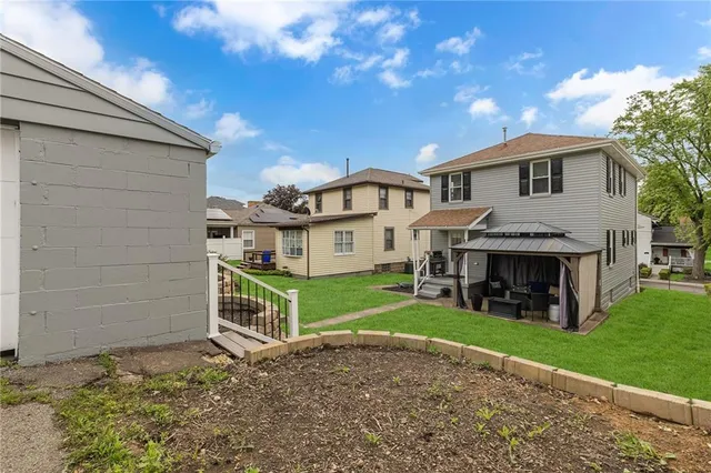 a view of a house with a yard and sitting area