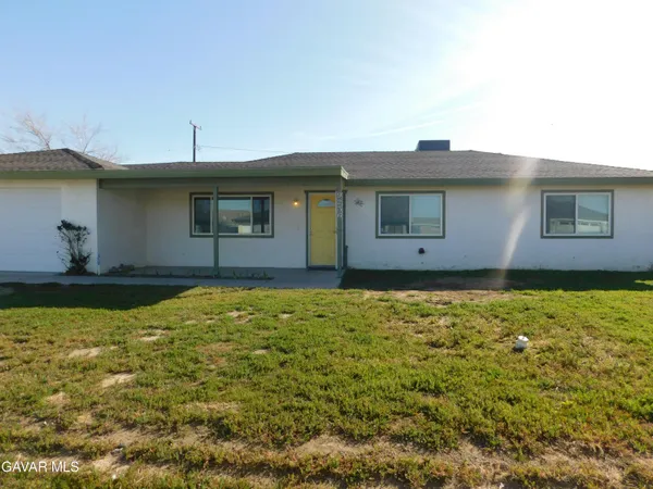 a view of house with yard