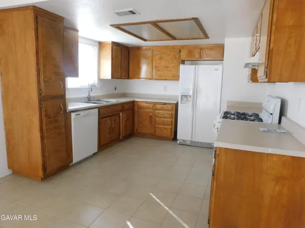 a kitchen with stainless steel appliances a refrigerator sink and cabinets