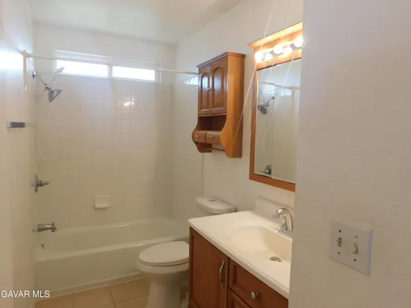 a bathroom with a sink toilet tub and shower