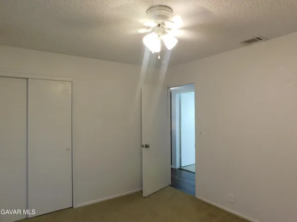a view of a chandelier fan and closet in a room