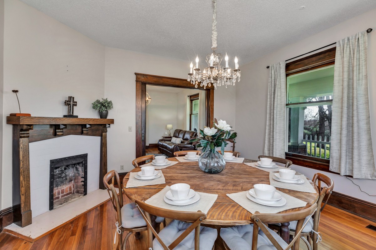 451 Wheelerton Road Dellrose, TN 38453 - Photo 13 of 34 a view of a dining room with furniture a chandelier and wooden floor