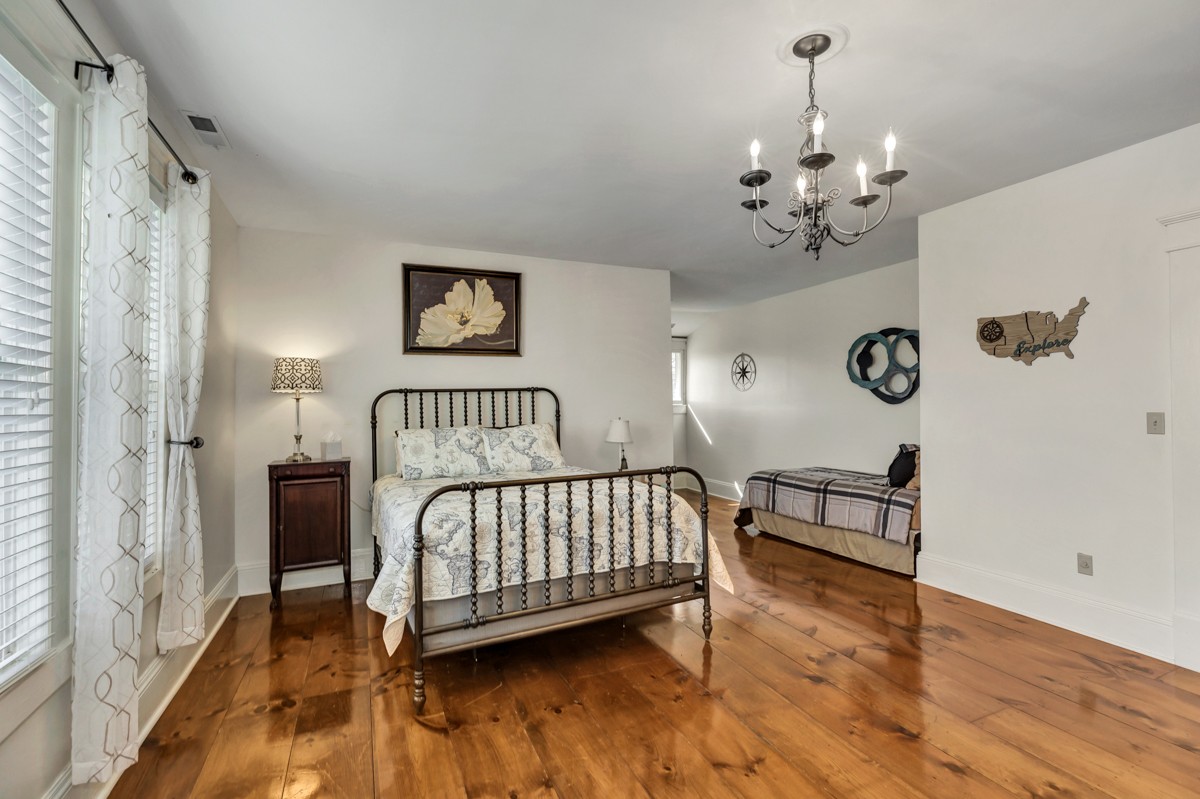 451 Wheelerton Road Dellrose, TN 38453 - Photo 21 of 34 a bedroom with a bed and a chandelier