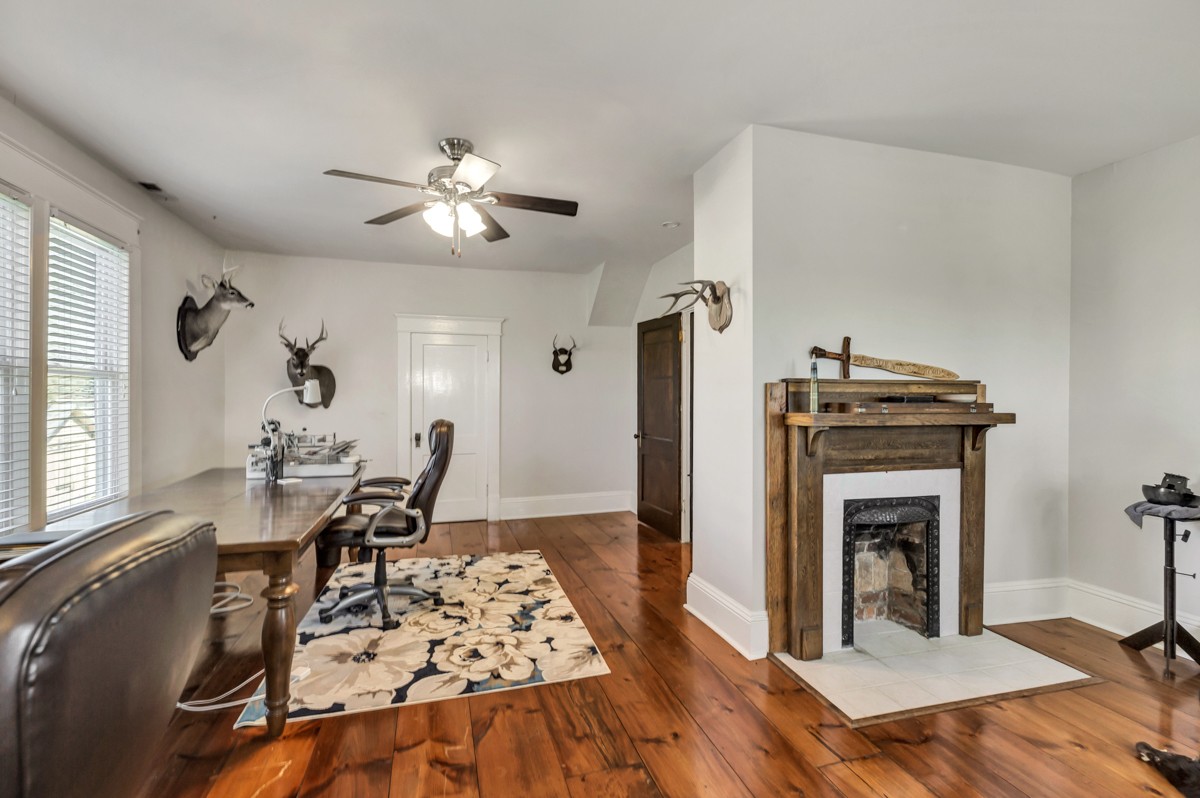 451 Wheelerton Road Dellrose, TN 38453 - Photo 25 of 34 a living room with furniture a chandelier and a fireplace