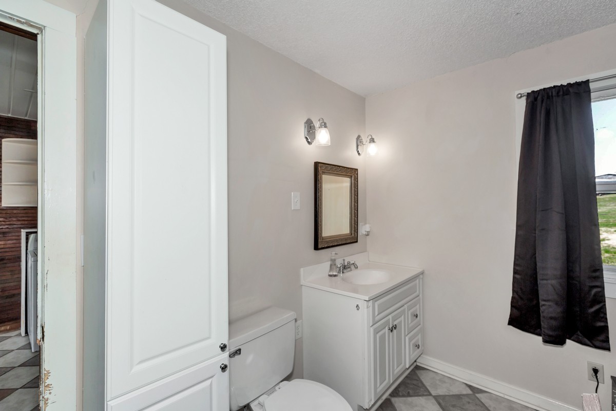 451 Wheelerton Road Dellrose, TN 38453 - Photo 27 of 34 a bathroom with a toilet sink and mirror