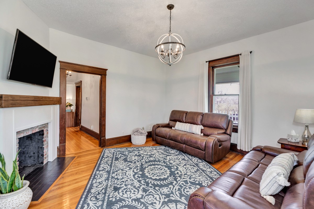 451 Wheelerton Road Dellrose, TN 38453 - Photo 6 of 34 a living room with furniture a flat screen tv and a fireplace