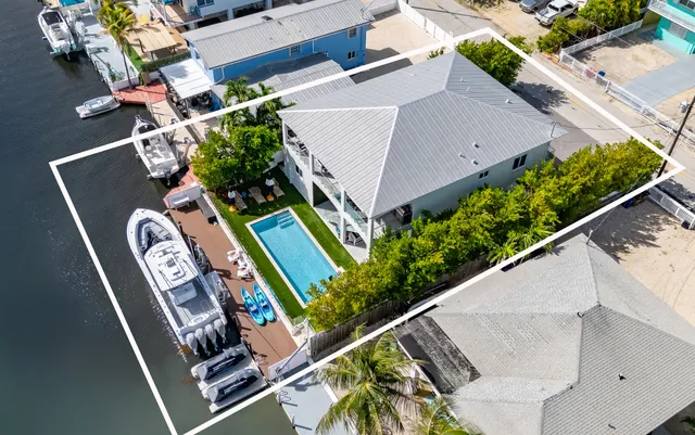 an aerial view of a chairs and table in the patio