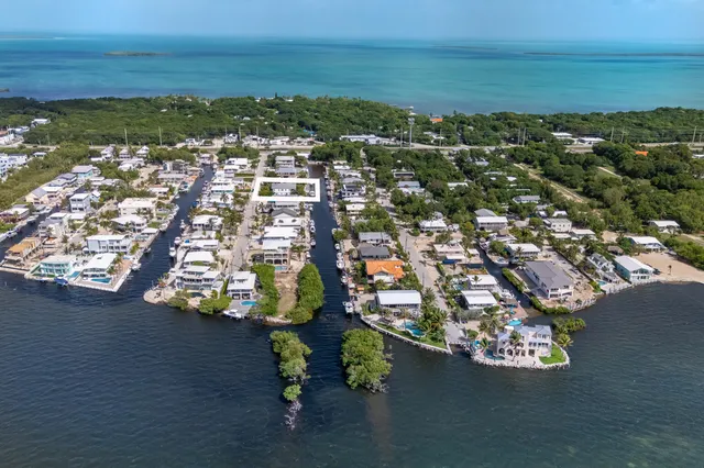 a front view of a house with a yard and a garage