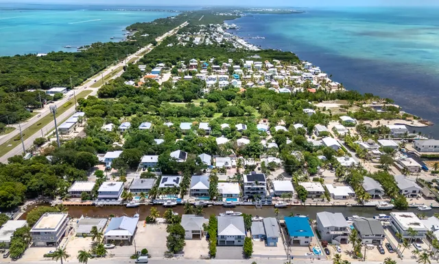 a view of a house with potted plants and a large window