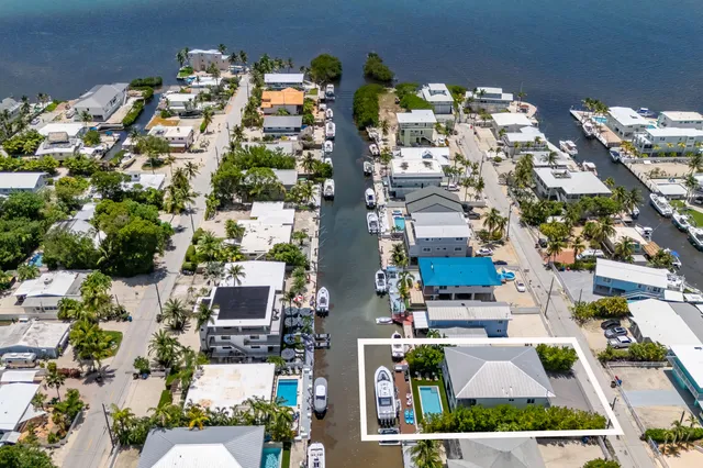 a view of an house with swimming pool and sitting area