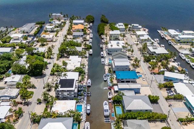 a view of a swimming pool with a lawn chairs under an umbrella