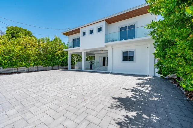 a living room with patio furniture and a potted plant
