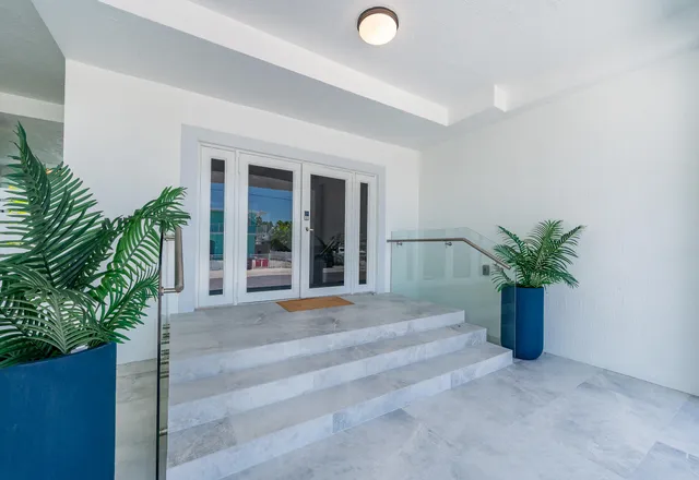 a living room with patio furniture and a fireplace