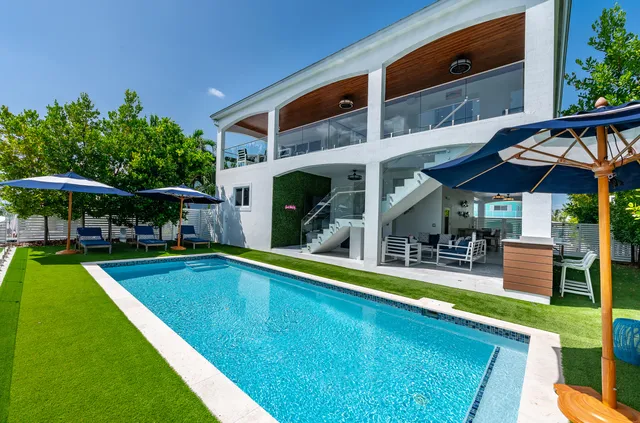 a view of swimming pool with outdoor seating and a garden