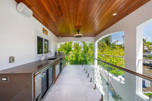 a en suite spacious bathroom with a granite countertop double vanity and a mirror