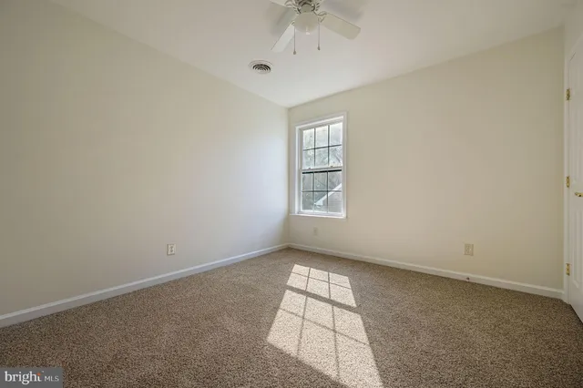 an empty room with windows and entrance