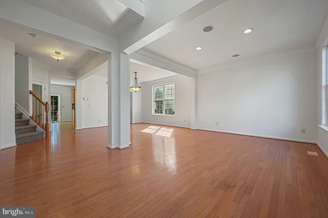 a view of a room with wooden floor and a window