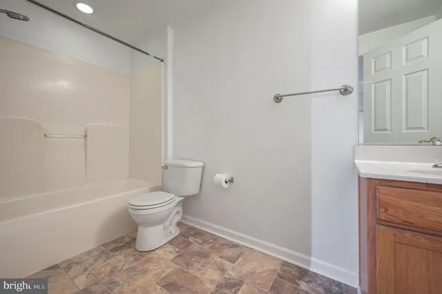 a bathroom with a toilet a sink and bathtub