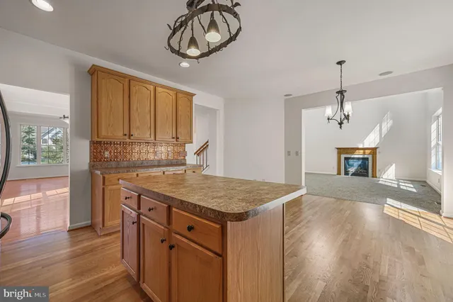 a kitchen with cabinets and wooden floor